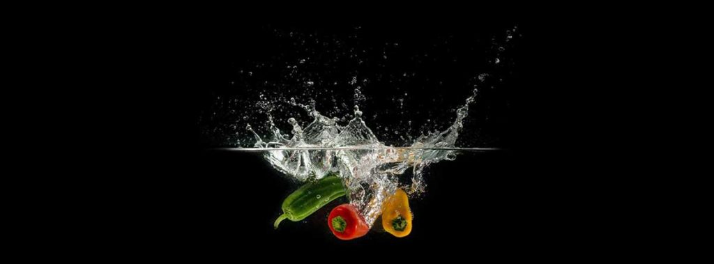 Vegetables in water on black background